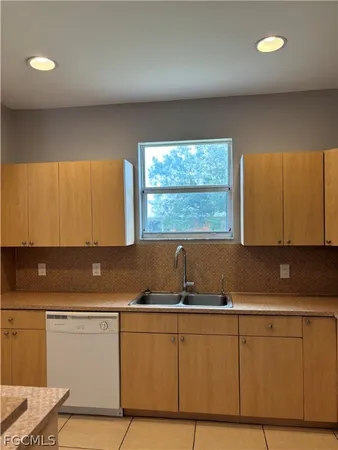 a kitchen with a sink cabinets and window