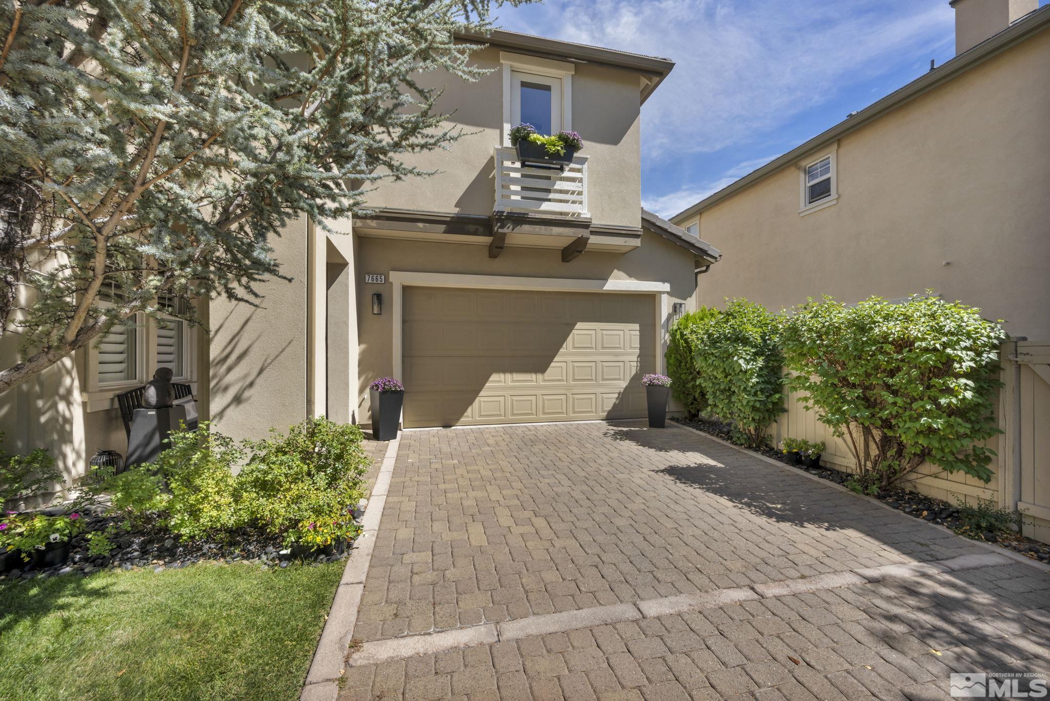 7665 Stone Bluff Way Reno, NV 89523 - Photo 1 of 40 front view of a house with a yard