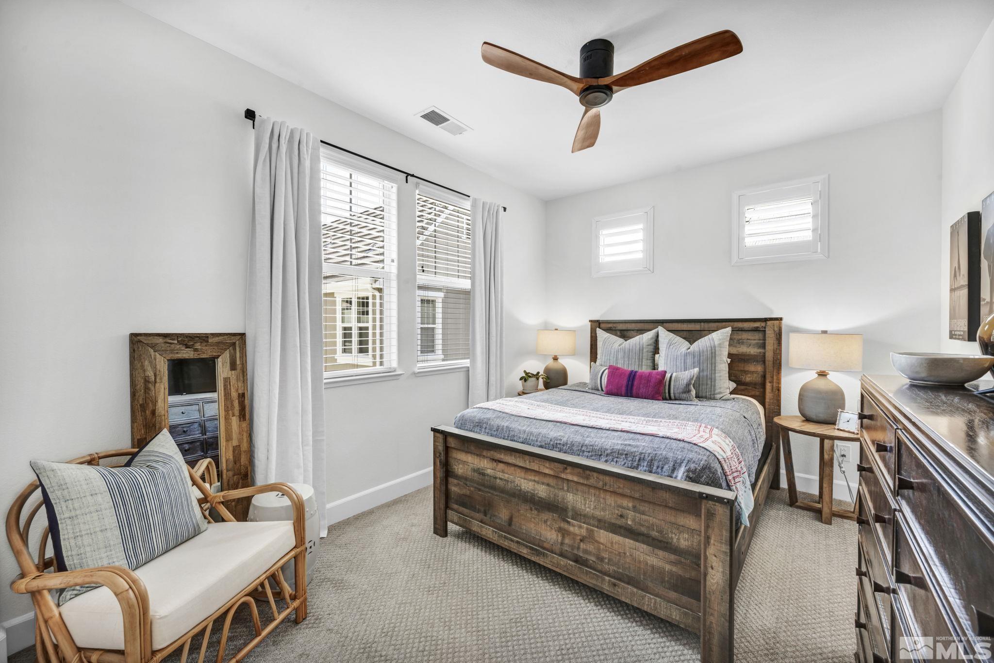 7665 Stone Bluff Way Reno, NV 89523 - Photo 17 of 40 a bedroom with a bed and wooden floor