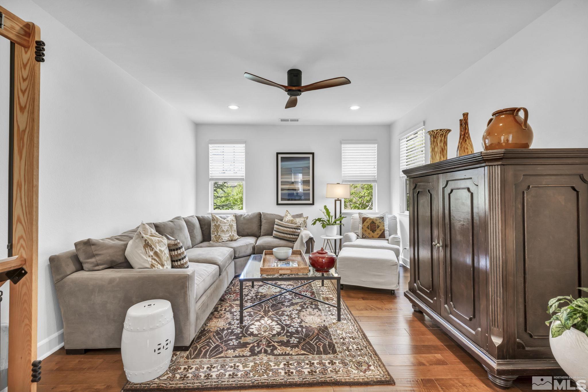 7665 Stone Bluff Way Reno, NV 89523 - Photo 19 of 40 a living room with furniture a ceiling fan and a rug