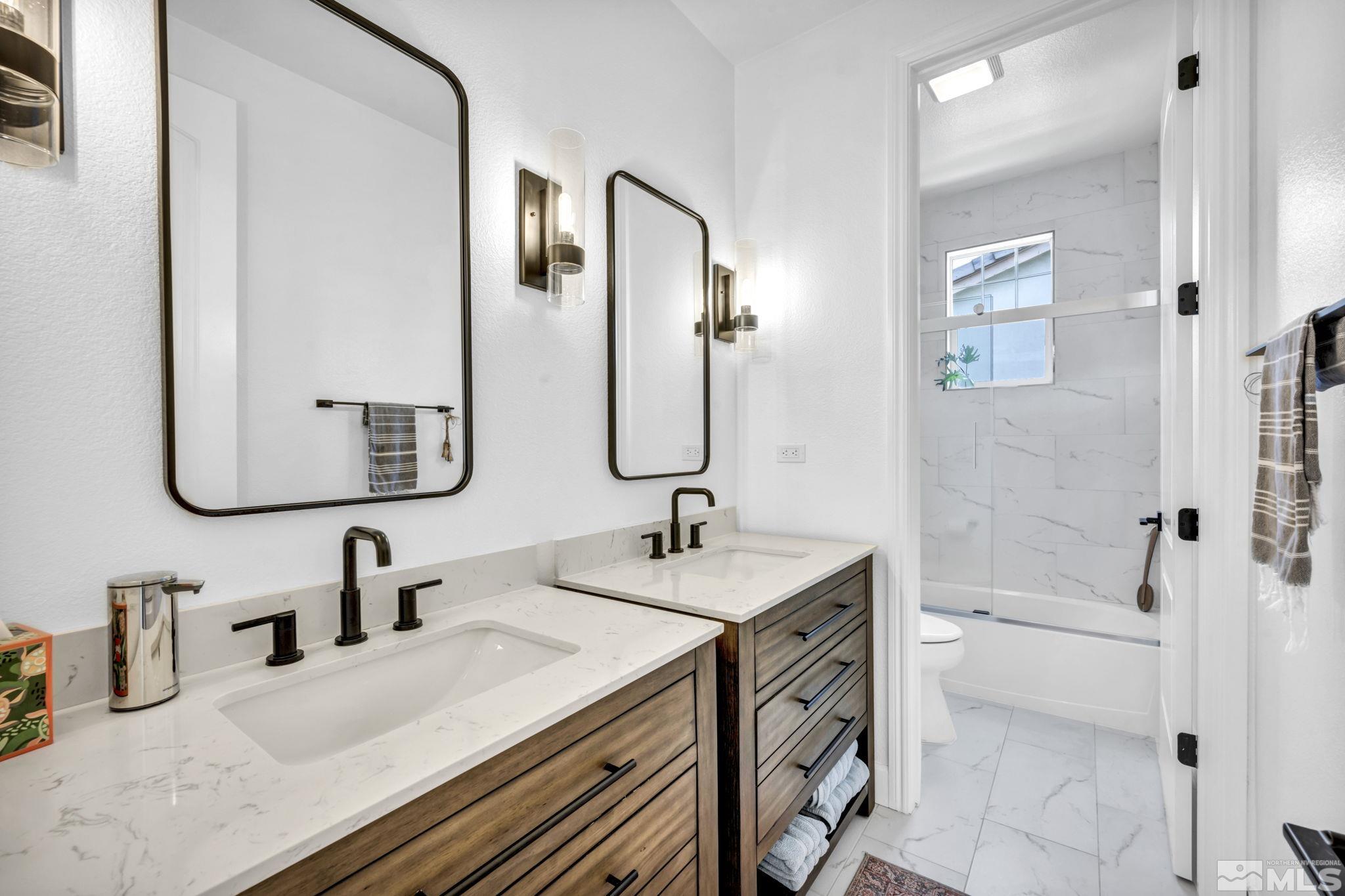 7665 Stone Bluff Way Reno, NV 89523 - Photo 21 of 40 a bathroom with a sink and a mirror