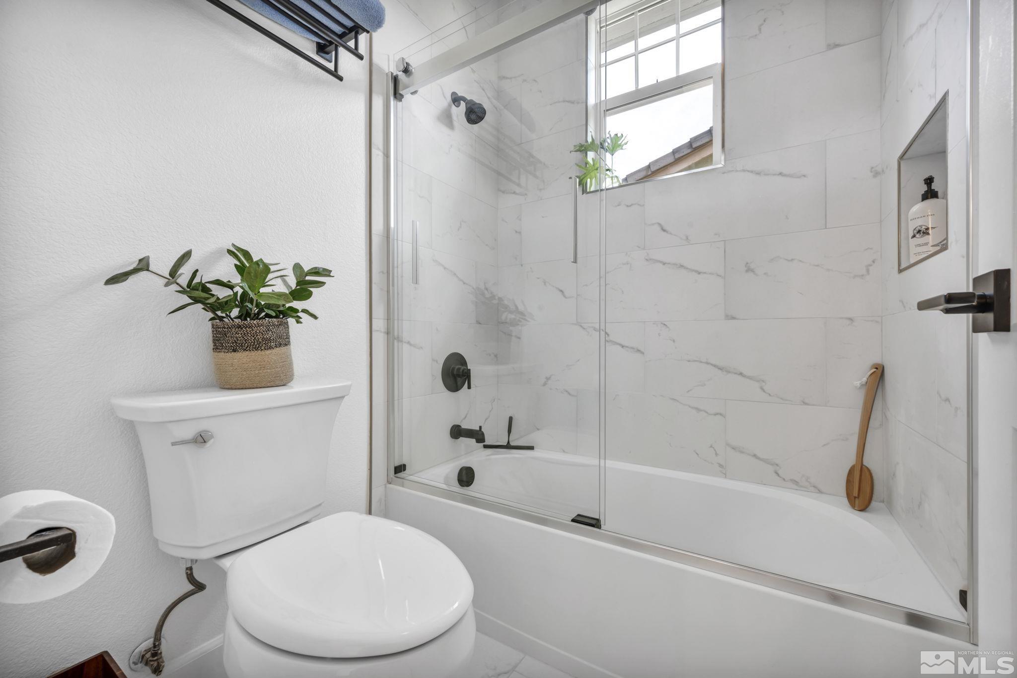 7665 Stone Bluff Way Reno, NV 89523 - Photo 22 of 40 a white toilet sitting next to a bath tub shower