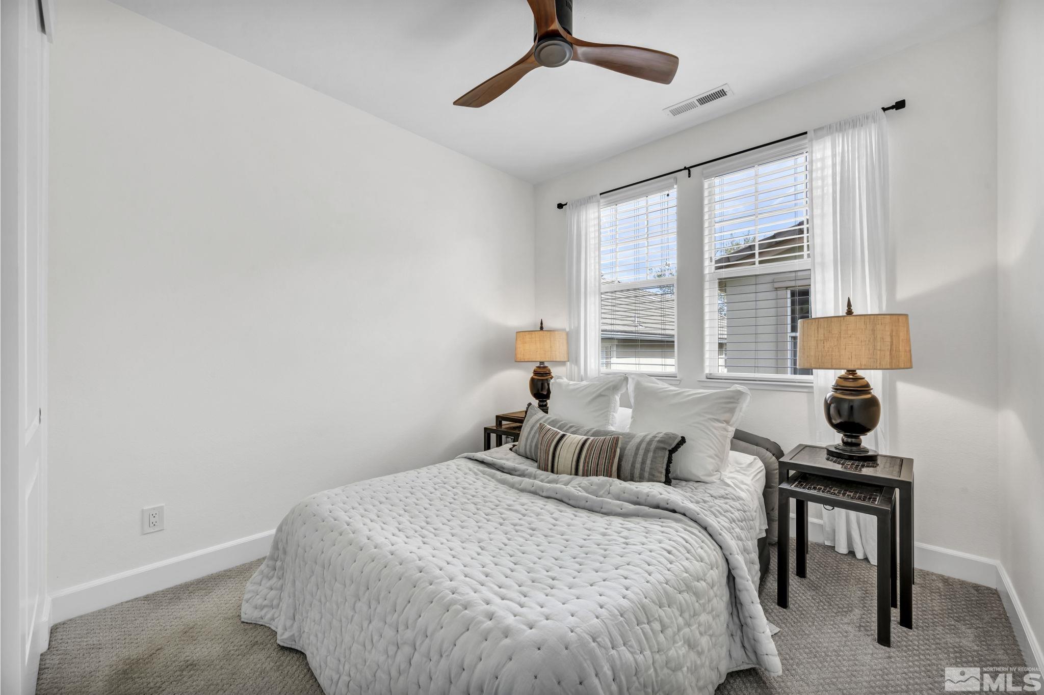 7665 Stone Bluff Way Reno, NV 89523 - Photo 23 of 40 a bedroom with a bed and window