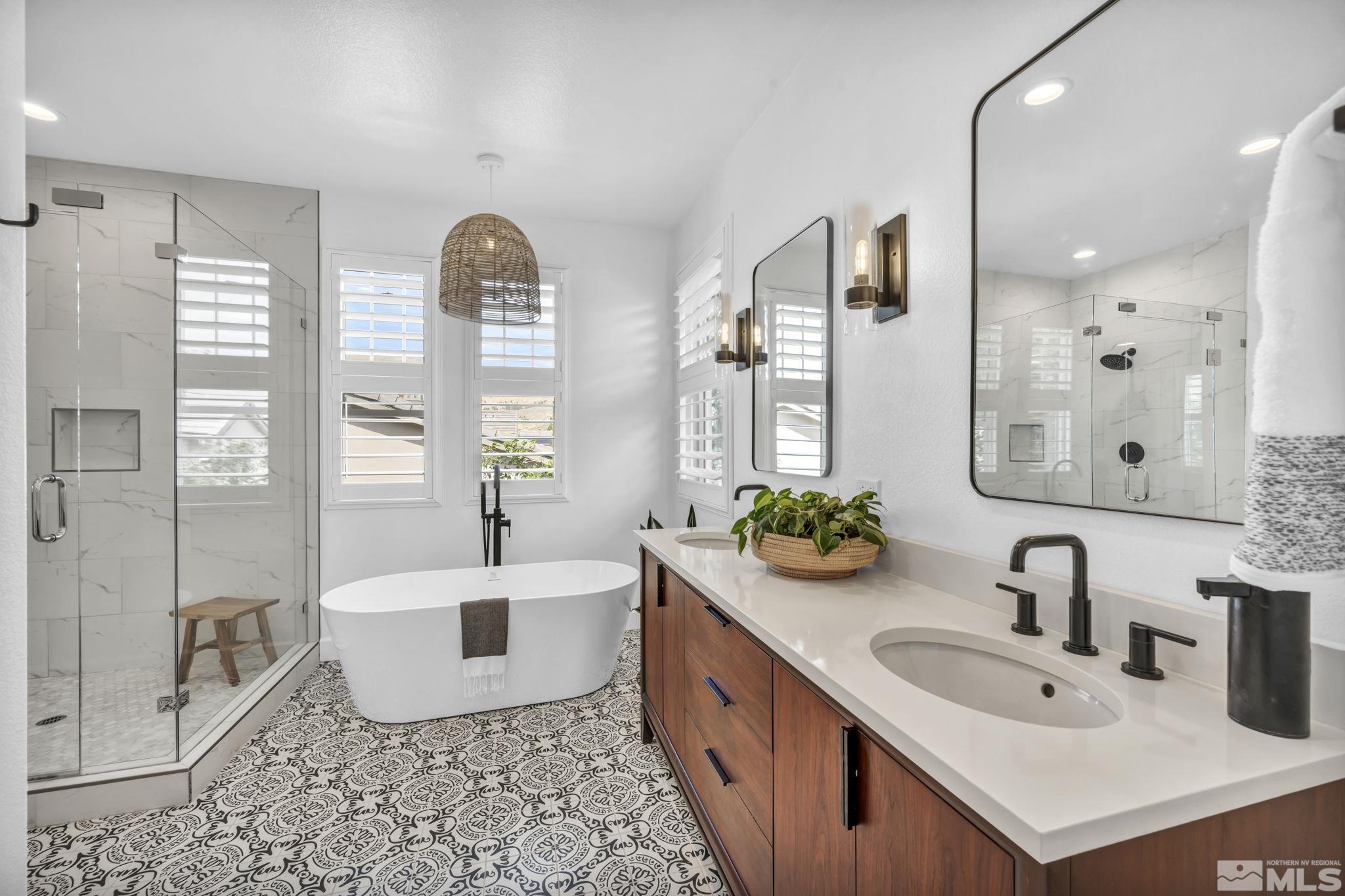 7665 Stone Bluff Way Reno, NV 89523 - Photo 29 of 40 a spacious bathroom with a tub sink and mirror