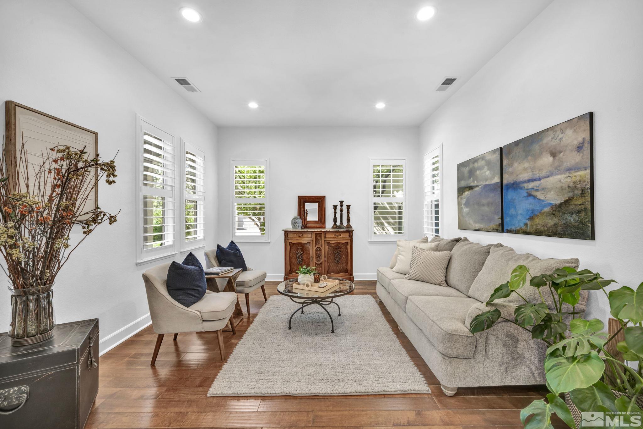 7665 Stone Bluff Way Reno, NV 89523 - Photo 4 of 40 a living room with fireplace furniture and a large window