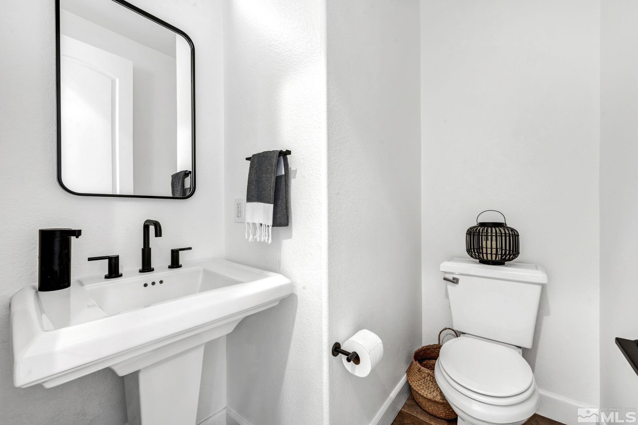 7665 Stone Bluff Way Reno, NV 89523 - Photo 8 of 40 a bathroom with a toilet sink and mirror
