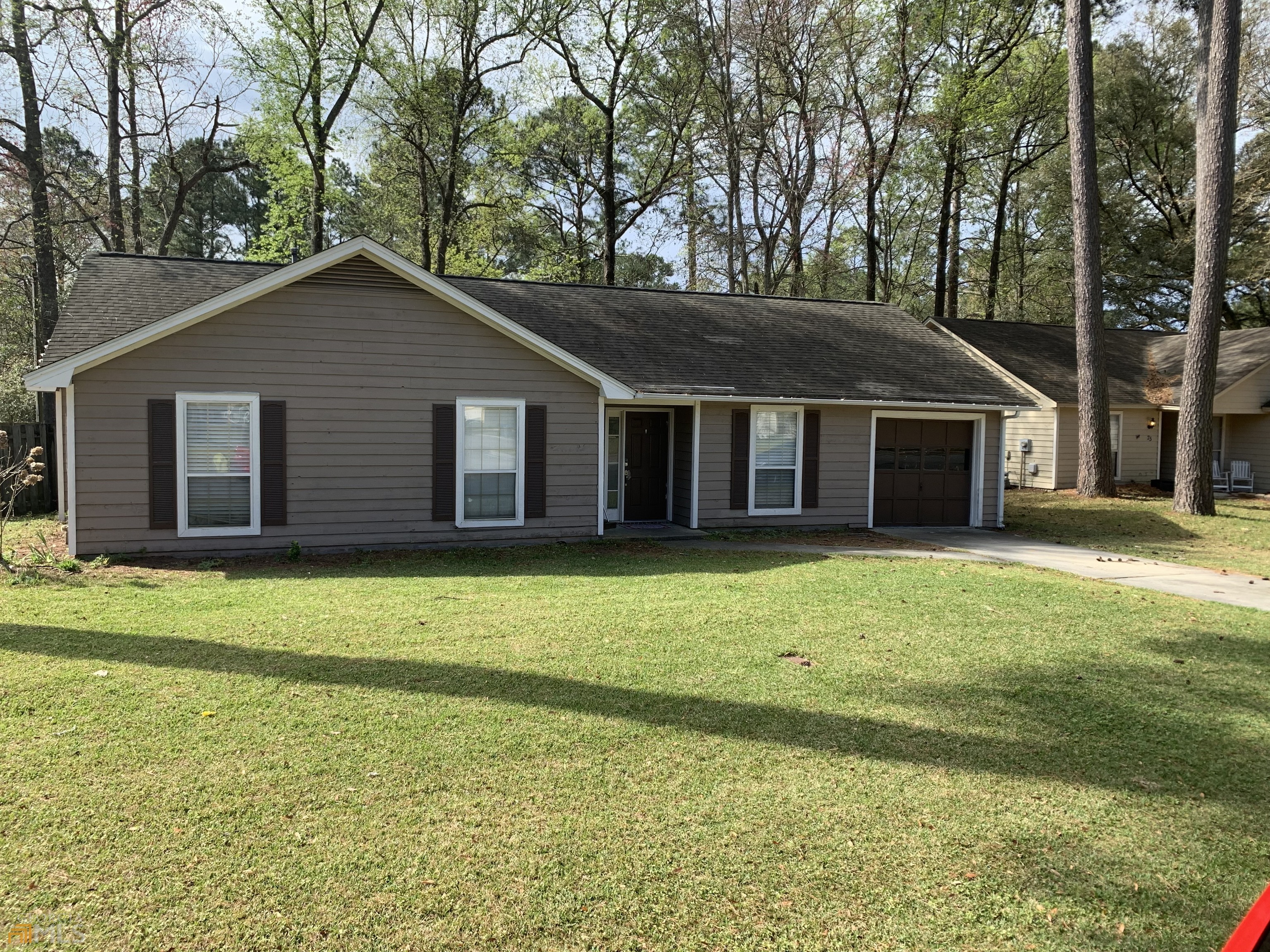 a front view of a house with a garden