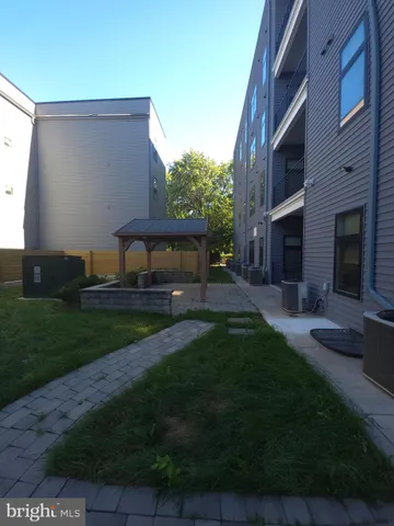 a view of house with garden and tall trees