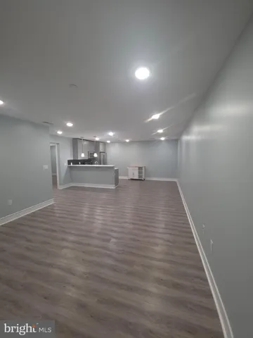 a view of a room with wooden floor