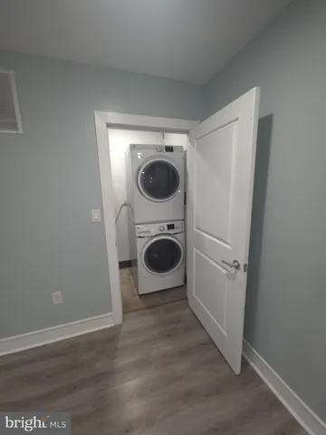 a view of a kitchen with a sink and a washer dryer