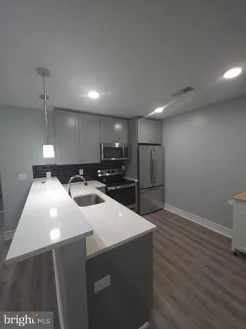 a kitchen with stainless steel appliances a refrigerator and a stove