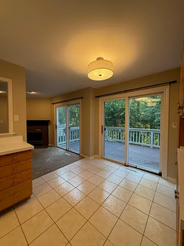 a view of an empty room with a fireplace and a large window