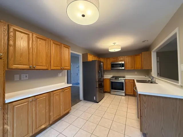 a kitchen with stainless steel appliances a refrigerator sink and cabinets