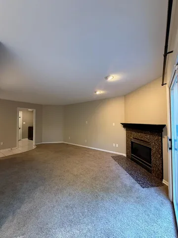a view of empty room with a fireplace