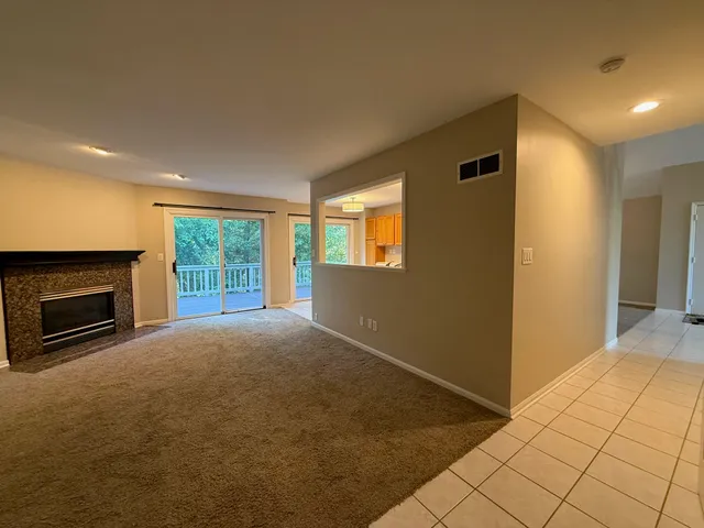 a view of empty room with windows and fireplace