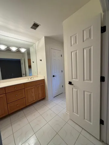 a spacious bathroom with a double vanity sink and a mirror