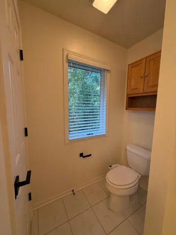 a white toilet sitting next to a bathroom sink