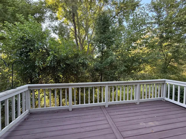 a view of wooden deck and a yard