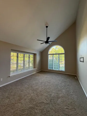 an empty room with a empty space and windows