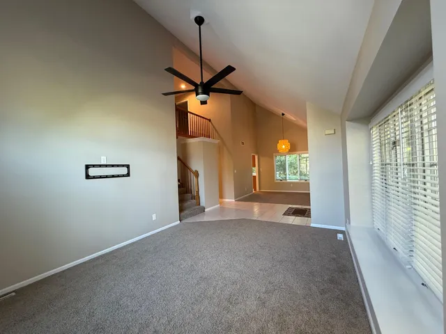 a view of a livingroom with a ceiling fan and window