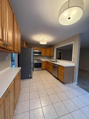 a kitchen with stainless steel appliances a stove a sink and a refrigerator