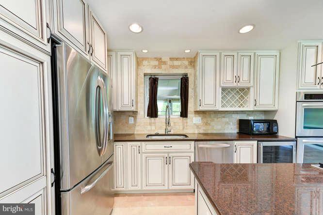 5918 Atteentee Road Springfield, VA 22150 - Photo 10 of 25 a kitchen with stainless steel appliances granite countertop a refrigerator a stove and a sink