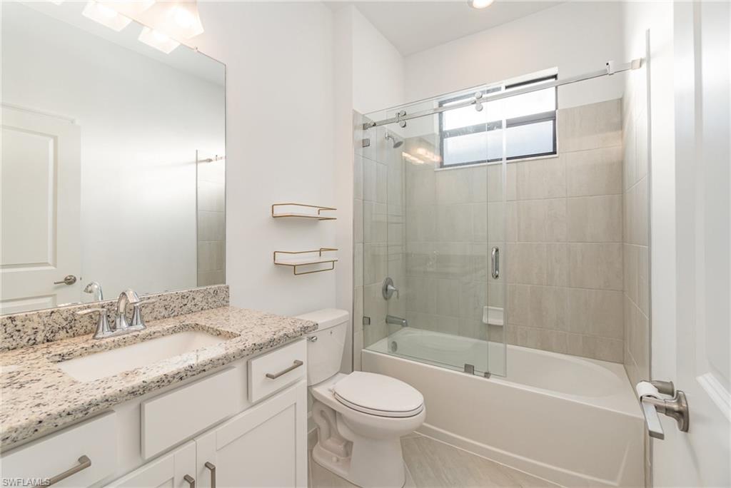 11127 Canopy Loop Fort Myers, FL 33913 - Photo 13 of 29 Full bathroom with vanity and combined bath / shower with glass door