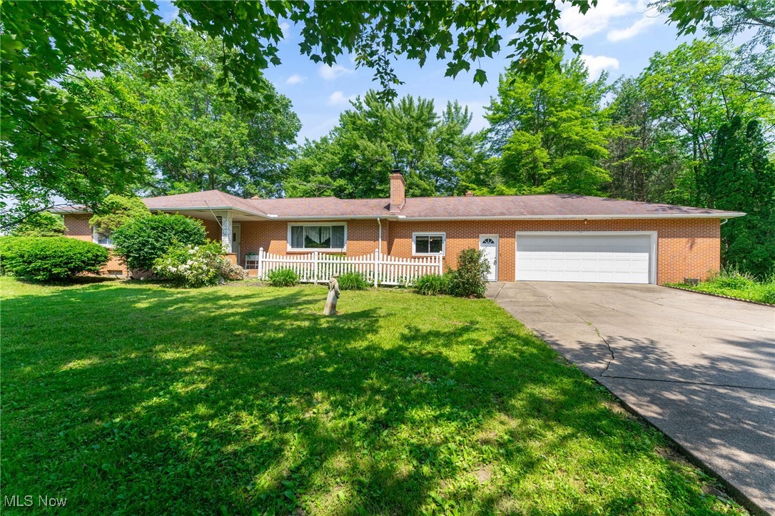 3612 Ridge Road Cortland, OH 44410 - Photo 1 of 36 Ranch-style house with brick siding, a garage, a chimney, concrete driveway, and a front yard