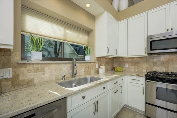 a dining room with furniture a chandelier and wooden floor
