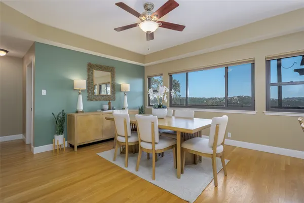 a bathroom with a granite countertop toilet a sink and mirror