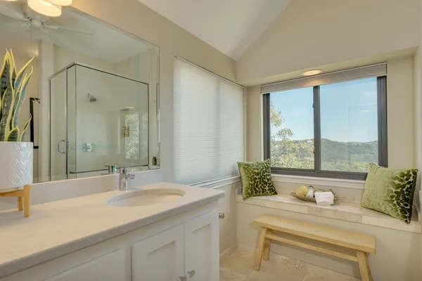 an empty room with a window and a fan