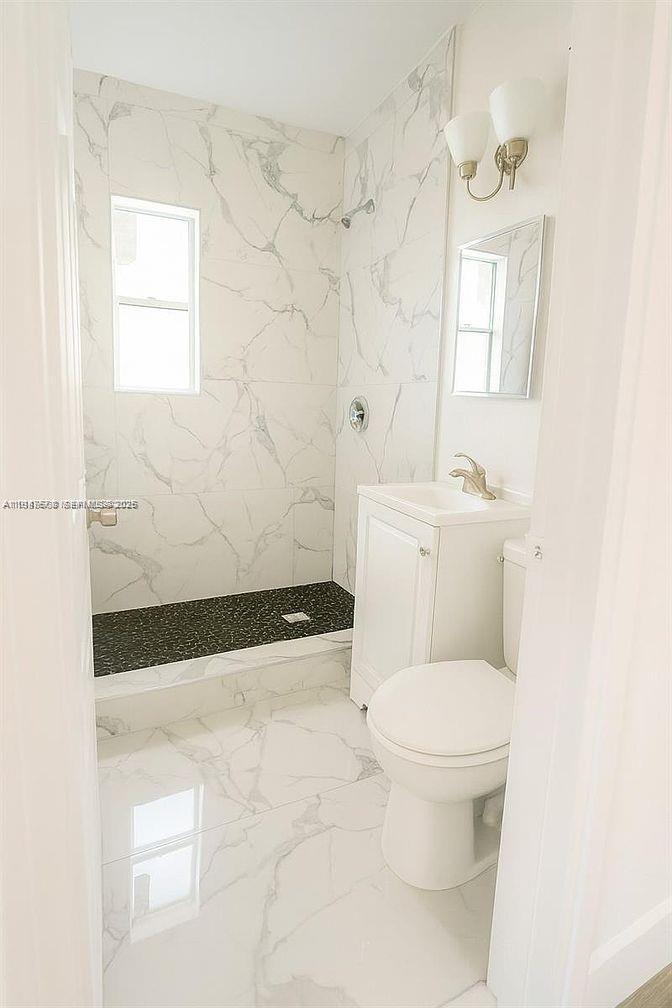 5825 Southwest 9th Terrace, Unit 2 West Miami, FL 33144 - Photo 6 of 11 a bathroom with a toilet a sink and a shower
