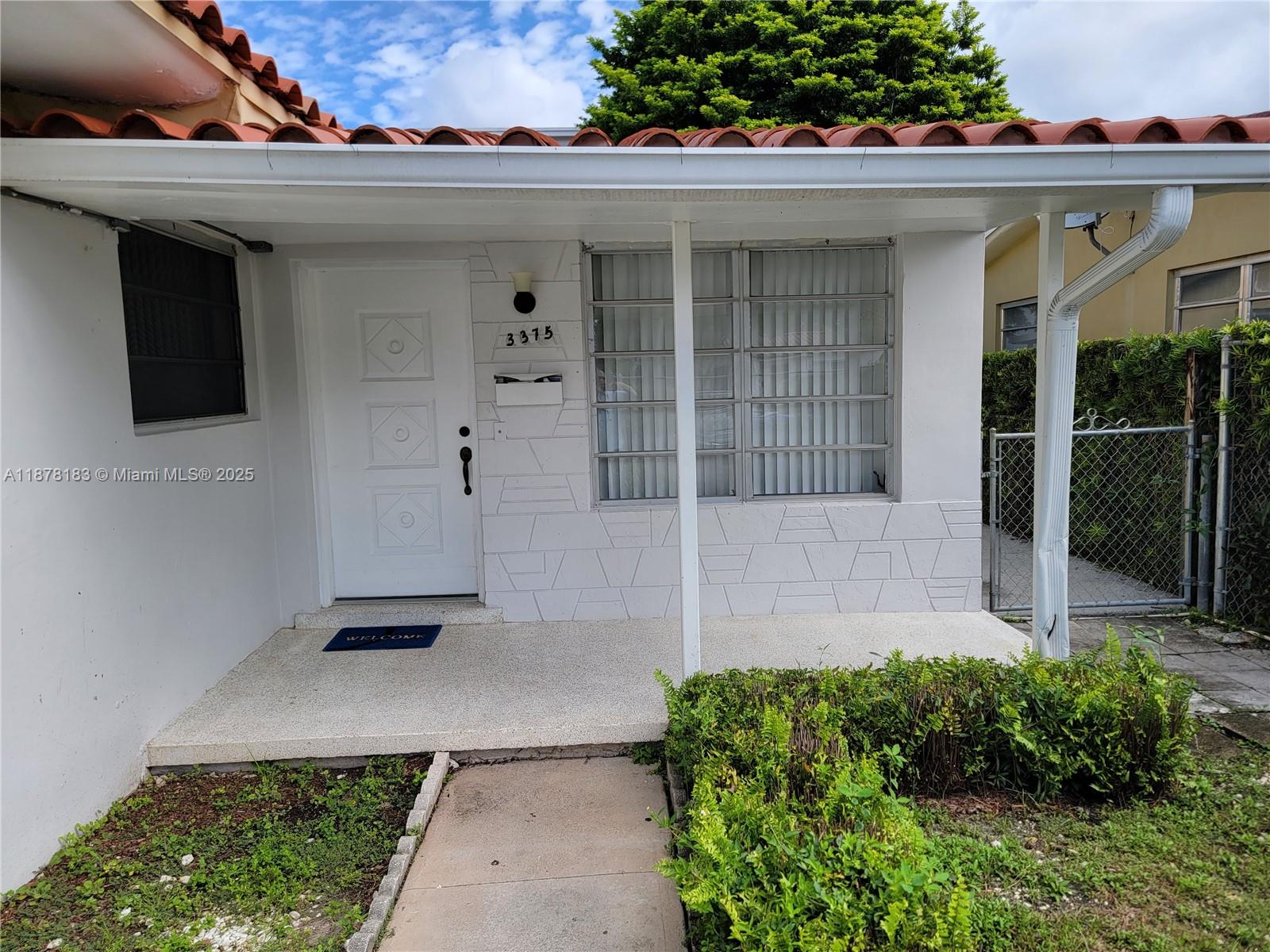 3375 Southwest 28th Street, Unit 3375 Miami, FL 33133 - Photo 1 of 20 a front view of a house with a porch