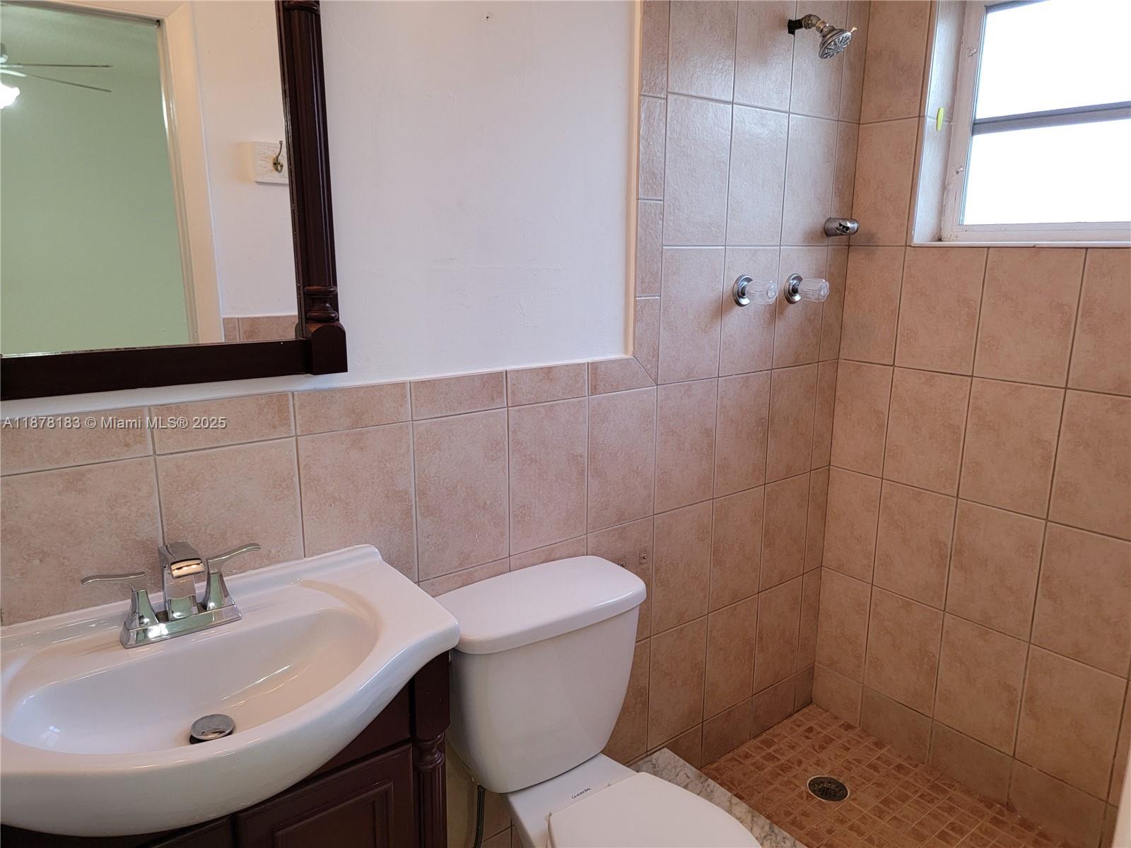 3375 Southwest 28th Street, Unit 3375 Miami, FL 33133 - Photo 14 of 20 a bathroom with a sink a toilet and shower