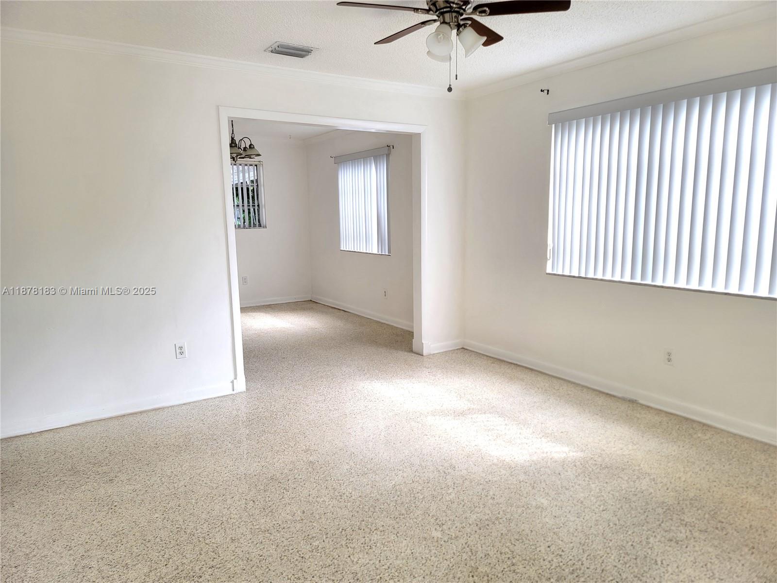 3375 Southwest 28th Street, Unit 3375 Miami, FL 33133 - Photo 3 of 20 an empty room with a window and a ceiling fan