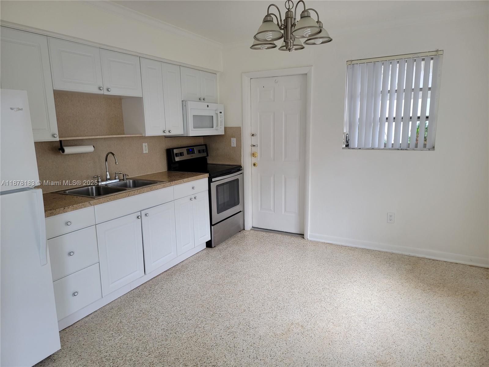 3375 Southwest 28th Street, Unit 3375 Miami, FL 33133 - Photo 4 of 20 a kitchen with a sink and cabinets