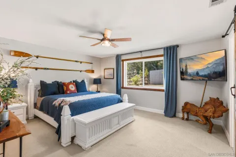 a bed room with a bed and a chair