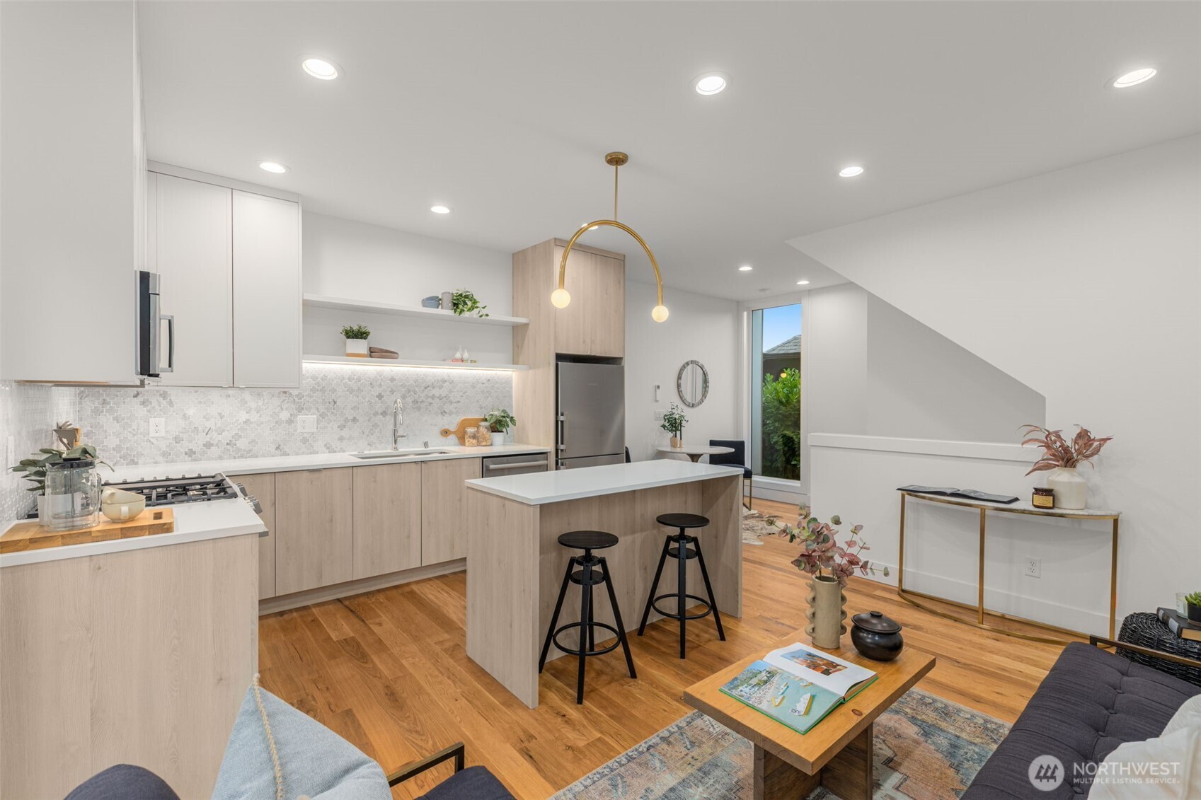 315 Northwest 86th Street, Unit B Seattle, WA 98117 - Photo 4 of 17 a kitchen with a sink cabinets and wooden floor