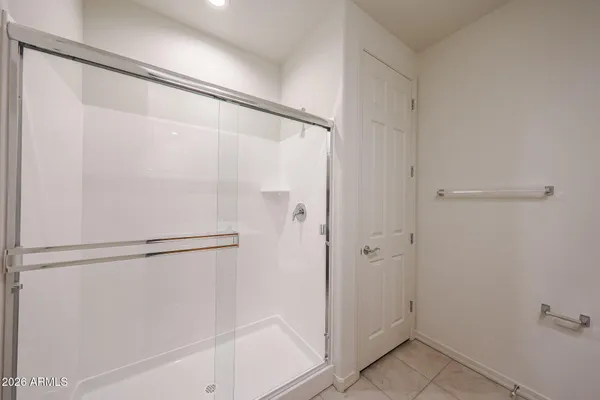 a bathroom with a glass shower door