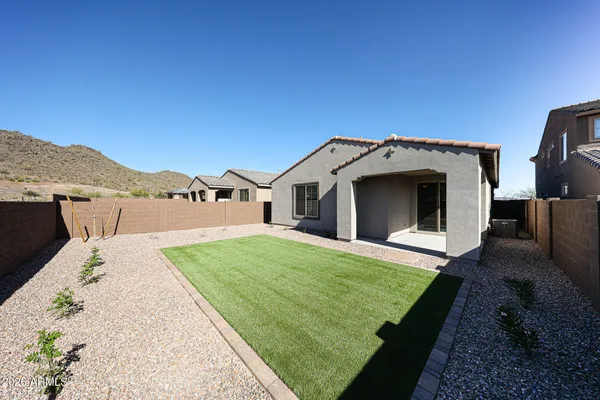a view of an house with backyard space and balcony