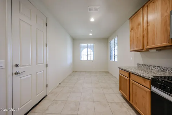 a view of a kitchen with an empty space and a window