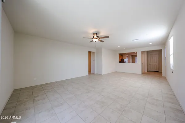 a view of a livingroom with a ceiling fan and window