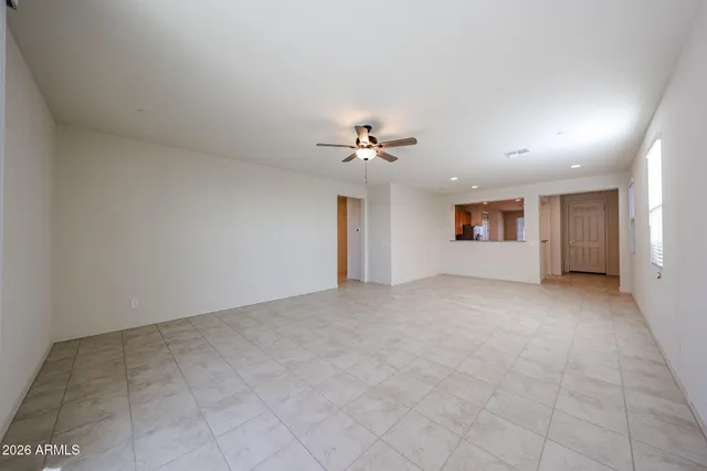 a view of a livingroom with a ceiling fan and window