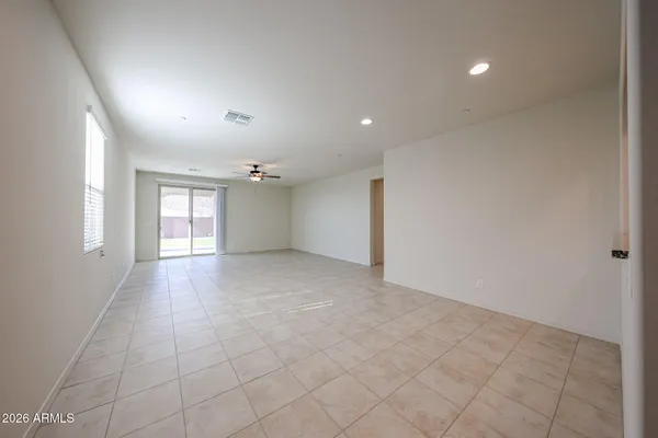 an empty room with windows and entrance