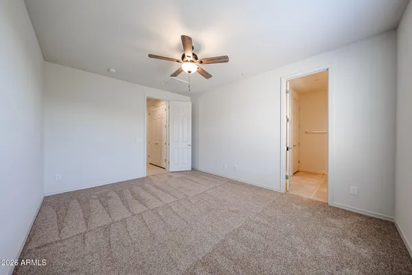 a view of an empty room with a ceiling fan