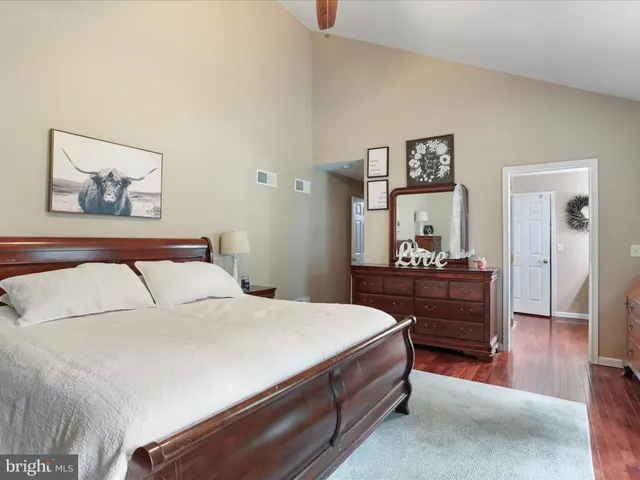 a bathroom with a granite countertop sink toilet and mirror