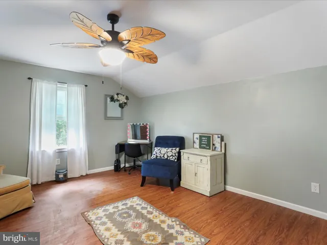 a bedroom with a bed and ceiling fan