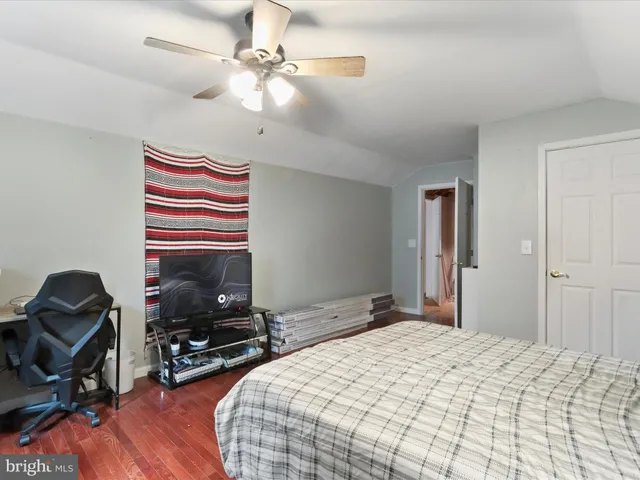 a living room with furniture a flat screen tv and a table