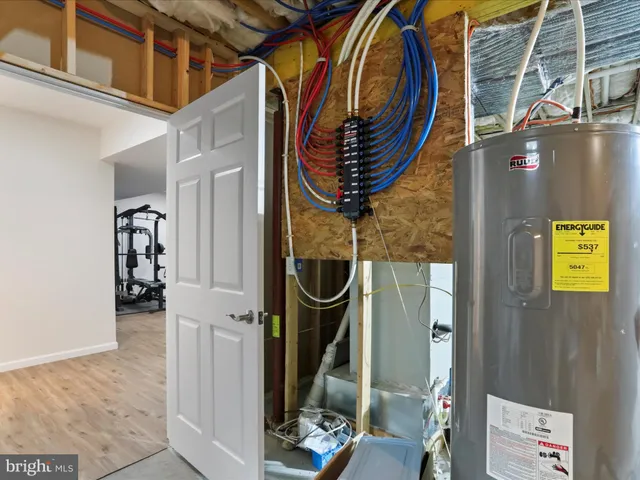 a backyard of a house with table and chairs plants and large tree
