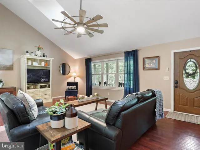 a kitchen with stainless steel appliances granite countertop a sink a stove and chairs